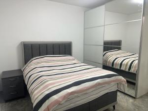 a bedroom with two beds and a mirror at maison individuelles pour 16 personnes in Lieusaint