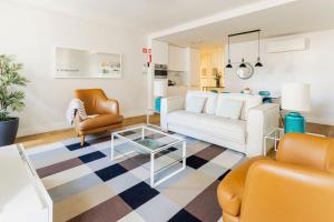 a living room with a couch and a table at Chiado Square Apartments | Lisbon Best Apartments in Lisbon