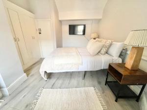 a small bedroom with a bed and a table at Soho Guest House Room 6 in London +10 photos
