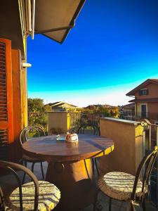 a table and chairs on a balcony with a view at Il corbezzolo in Linguaglossa