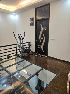 a glass floor in a building with a sculpture on the wall at Ashirwaad 249 in Greater Noida