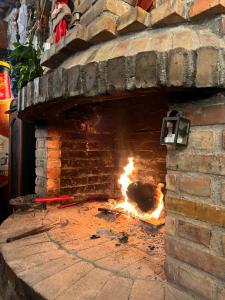 a brick oven with a fire in it at Hotel Panorama Zogaj in Zogaji