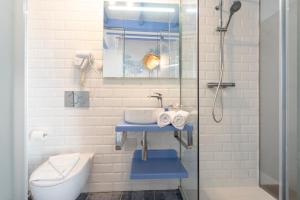 a bathroom with a sink and a toilet and a shower at The Old House Marbella in Marbella +29 photos