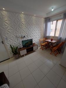a living room with a tv and a table at Condomínio São Francisco in Petrolina