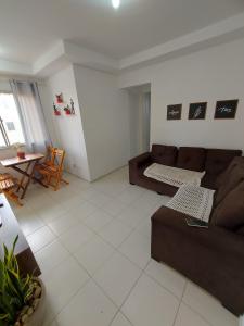 a living room with a couch and a table at Condomínio São Francisco in Petrolina