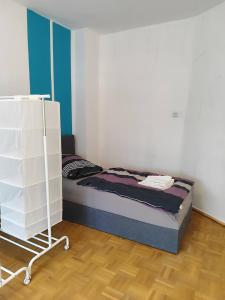 a small bedroom with a bed and a shelf at Ferienwohnung Belvie 2 in Butzbach