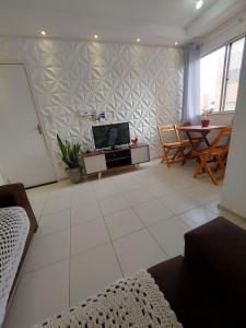 a living room with a tv and a table at Condomínio São Francisco in Petrolina