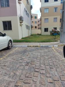 a car parked in a parking lot next to a building at Condomínio São Francisco in Petrolina