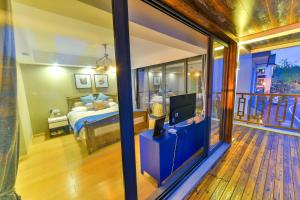 a bedroom with a bed and a tv in a room at Deluxe Double Balcony King Room Bathtub in Hangzhou