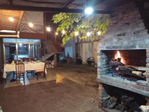 a living room with a stone fireplace and a table at La casa de Wanda in Oberá