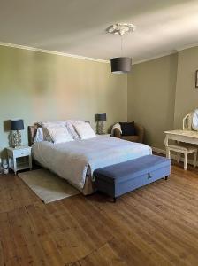 a bedroom with a large bed and two tables at La Maison Haute in La Fosse-de-Tigné