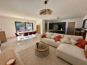 a living room with a couch and a table at Villa Provençale in Le Thor