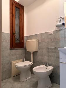 a bathroom with a toilet and a sink at Il corbezzolo in Linguaglossa +29 photos