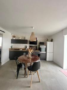 ル・テックにあるCasa Del Sol - T2 au Cœur du BassinPort Teich 5'のテーブルと椅子のあるキッチンとダイニングルーム