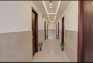 an empty hallway with potted plants in a building at SS Residency in Bengaluru