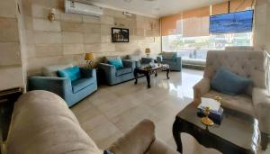 a large living room with couches and a table at AL Mokhmalia Serviced Apartments in Medina