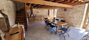 a dining room with a wooden table and chairs at Séjour à la campagne en Périgord Noir in La Cassagne