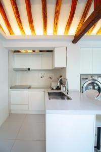 a kitchen with white cabinets and a sink at Cheongryang-Anchae 2BR 2BA Hanok Spa Free Parking in Seoul +70 photos