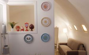 a living room with plates on a wall at Bari Vecchia Suite in Bari