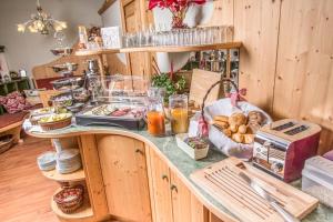 a kitchen with a counter with food on it at Apart-Pension Oberreiter in Fusch an der Glocknerstraße +99 photos