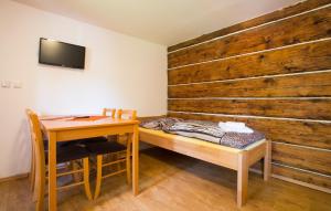 a room with a desk and a bed and a table at Penzion U Vyhlídky in Chřibská