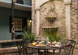 a table with food and a statue of a lion at Indigo Inn in Charleston