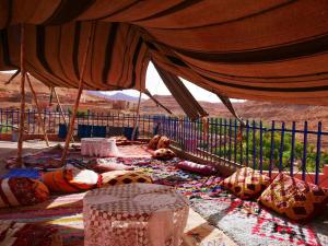 a tent with a lot of stuff on the ground at Grotte Salwa in Aït Benhaddou