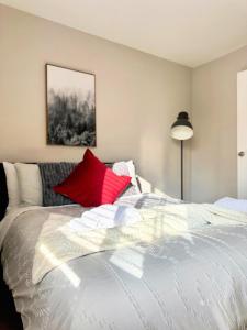 a bedroom with a white bed with red pillows at Fire Support 3Bedroom Modern Luxury House in Central Pasadena in Pasadena