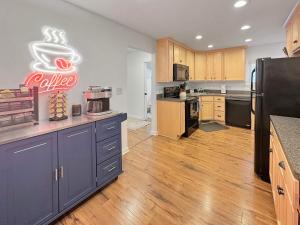 a kitchen with a large kitchen with a coffee sign on the wall at Coffee Lover's Paradise - Heart of Tremont in Cleveland