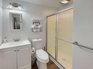a bathroom with a toilet and a glass shower stall at Coffee Lover's Paradise - Heart of Tremont in Cleveland +12 photos