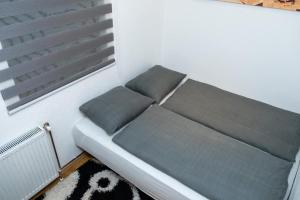 a couch sitting in a room with a window at Apartman KIKI in Kupres