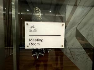 a sign in a glass door of a meeting room at Big screen cinema tv, 5 queen bed Luxury apt 2cp in Jelutong