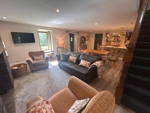 a living room with a couch and a table at Aldernaig Mill in Invergarry