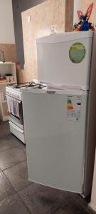 a white refrigerator and an oven in a kitchen at Departamento San Pedro, Buenos Aires in San Pedro