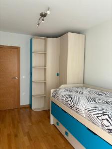 a bedroom with a bed and a closet at Apartamento El Cruce in Sarón +5 photos