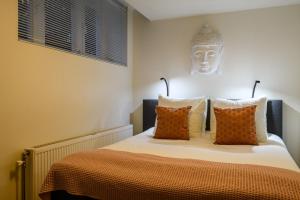 Postel nebo postele na pokoji v ubytování Hotel Oranjestaete