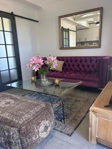 a living room with a couch and a glass table at Nora's Place in Sedgefield +61 photos