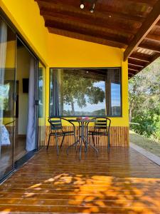 a patio with a table and chairs on a porch at Recanto dos Campos in Monte Alegre do Sul +39 photos