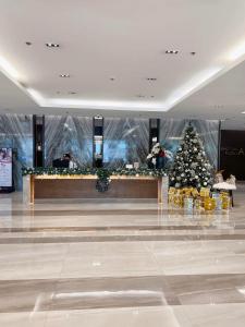 a christmas tree in the middle of a mall at La Chicka Staycation in Coast Residences in Manila +58 photos