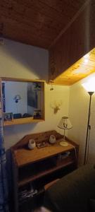 a living room with a table and a lamp at Appartement dernier étage au pied des pistes HIRMENTAZ in Bellevaux +14 photos