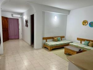 a living room with two couches and a table at Family-Friendly Studio in Mahdia
