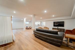 a living room with a leather couch and a television at Luxury getaway at The Winslow in Winslow