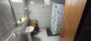 a bathroom with a sink and a shower curtain at Lo de Toty 1 in Yapeyú +26 photos