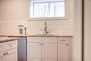 a kitchen with white cabinets and a sink and a window at Luxury getaway at The Winslow in Winslow +24 photos