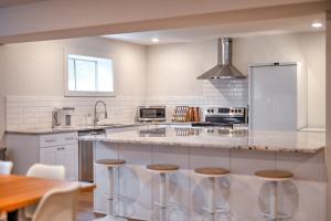 a kitchen with a large island with bar stools at Luxury getaway at The Winslow in Winslow