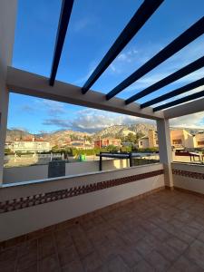 a balcony with a view of the mountains at VillaLuxury in Dúrcal