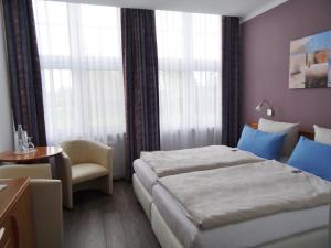 Lova arba lovos apgyvendinimo įstaigoje Landhotel Alte Schule - Hotel Garni