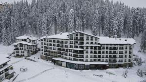 an aerial view of a hotel in the snow at Elit Pamporovo Accommodation in Pamporovo