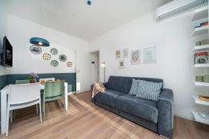 una sala de estar con un sofá y una mesa en Oberdan 5 Centro Storico - A Casa Tua, en Pordenone
