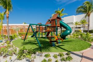 a playground at a resort with a slide at Luxury 2-Bedroom Apartment with Beach Club Access in Cancún